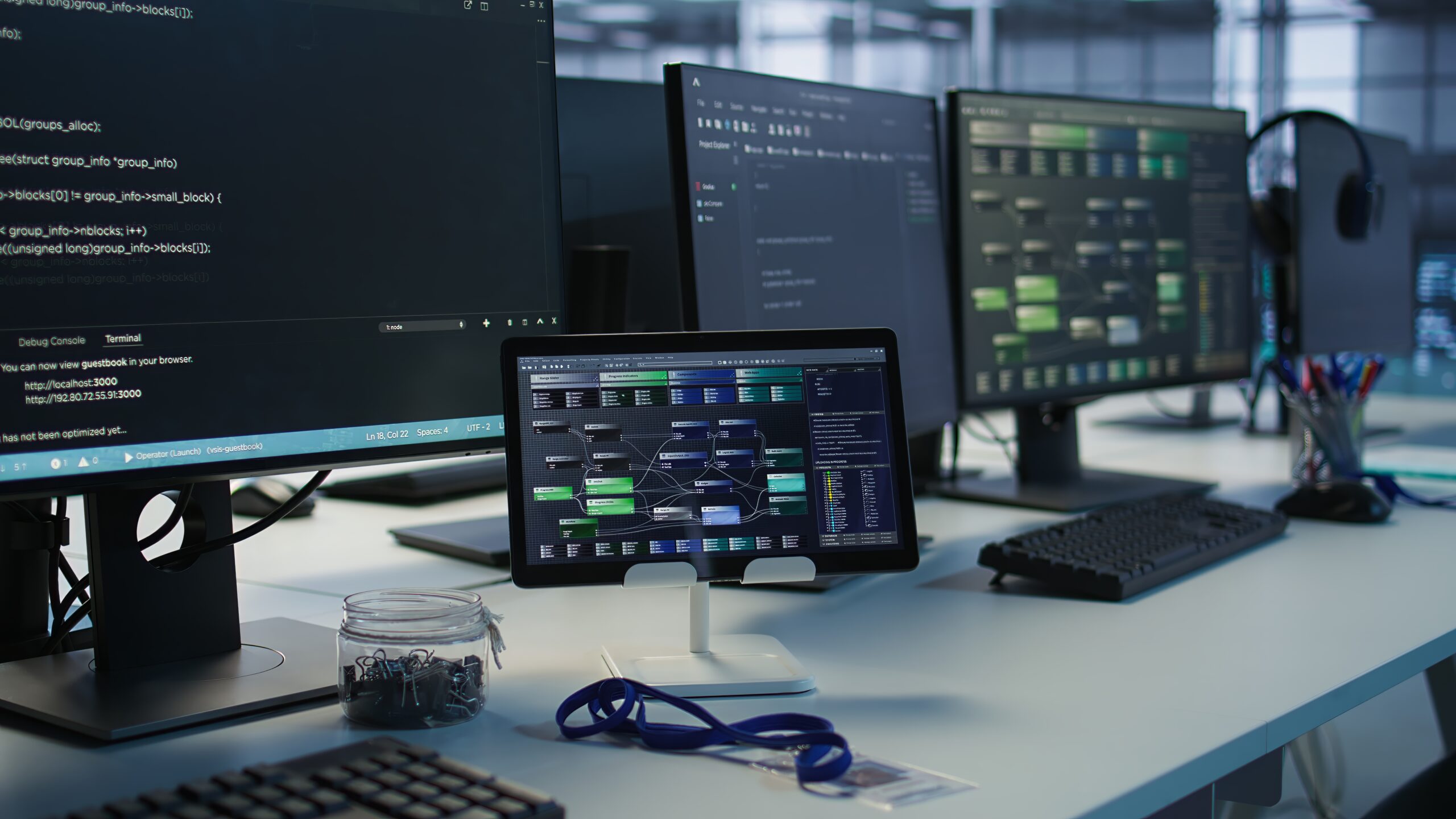 Equipment in data center workplace used for monitoring performance Close up of headphones left by worker on server room PCs used by employees working to ensure minimal downtime. Equipment in data center workplace used for monitoring performance
